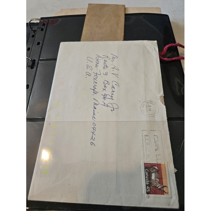 Envelope with handwritten address and Canadian stamp.