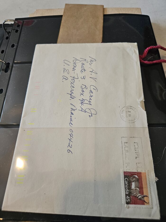 Envelope with handwritten address and Canadian stamp.