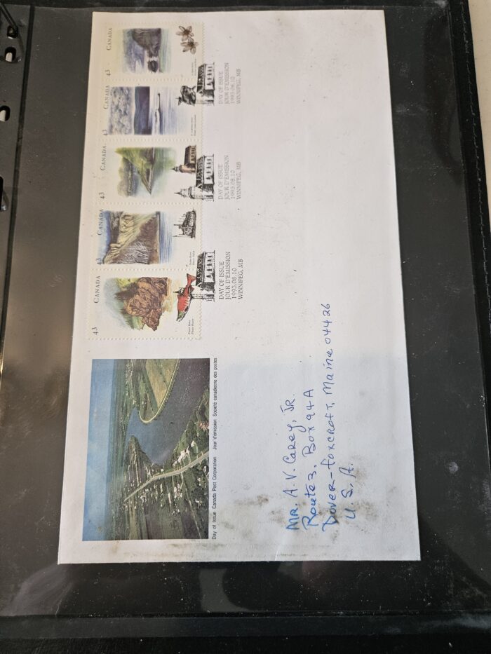 Canada stamps and postcard in protective sleeve.