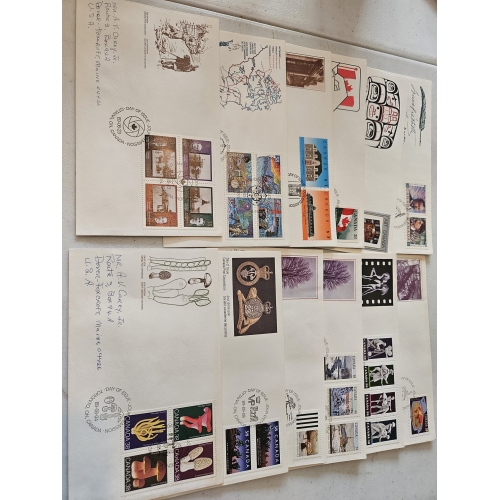Collection of Canadian stamped envelopes on table.
