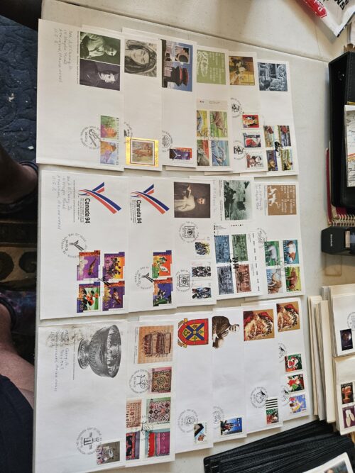 Collection of vintage commemorative postal covers on table.