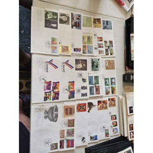 Collection of vintage commemorative postal covers on table.