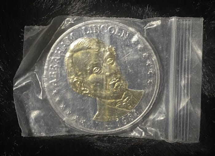 1984 Abraham Lincoln commemorative coin in plastic bag