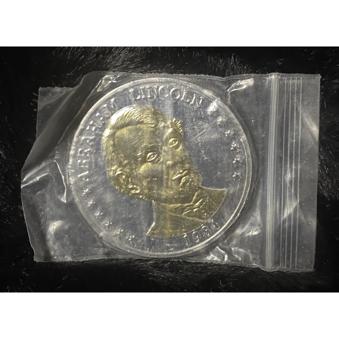 1984 Abraham Lincoln commemorative coin in plastic bag