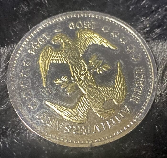 Golden coin with eagle design, 150th anniversary