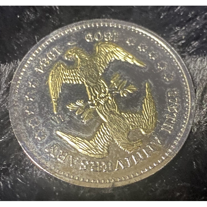 Golden coin with eagle design, 150th anniversary