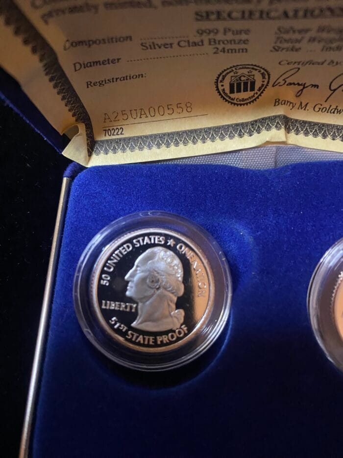 Commemorative coin with certificate and blue display case.