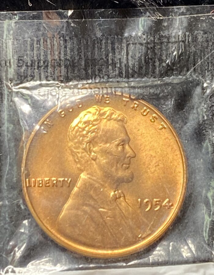 1954 Lincoln penny in plastic packaging.