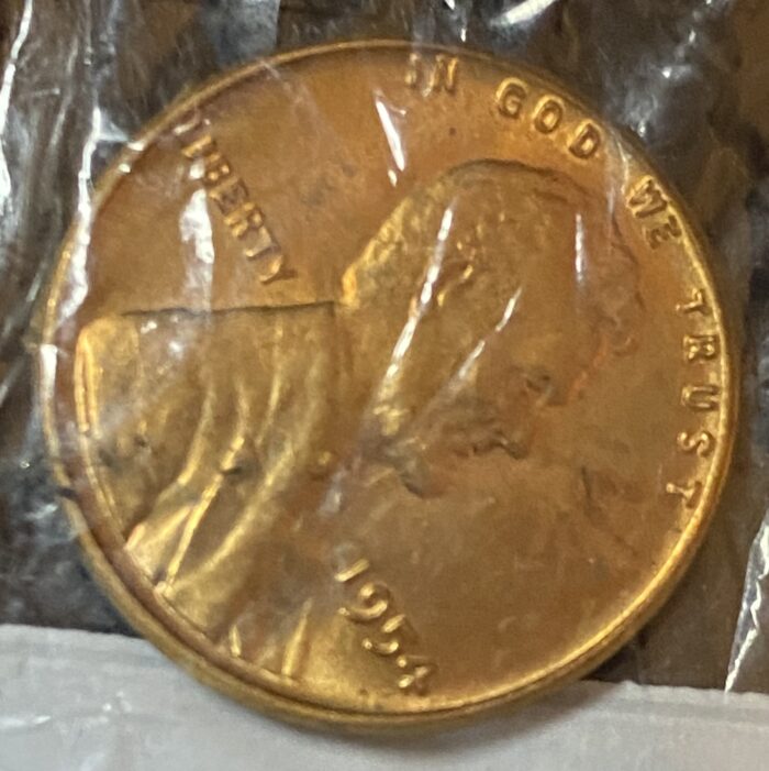 1954 Lincoln penny in plastic wrapper.