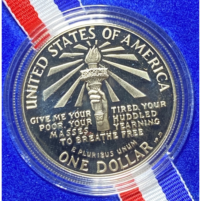 United States commemorative dollar coin with torch design.