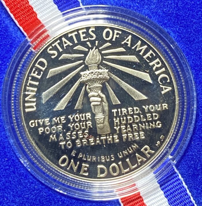 United States commemorative dollar coin with torch design.