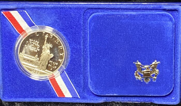 Commemorative coin in blue case with emblem.