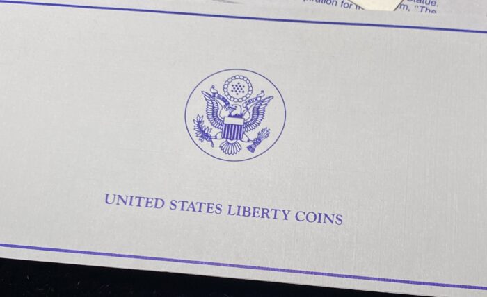 United States Liberty Coins certificate with emblem.