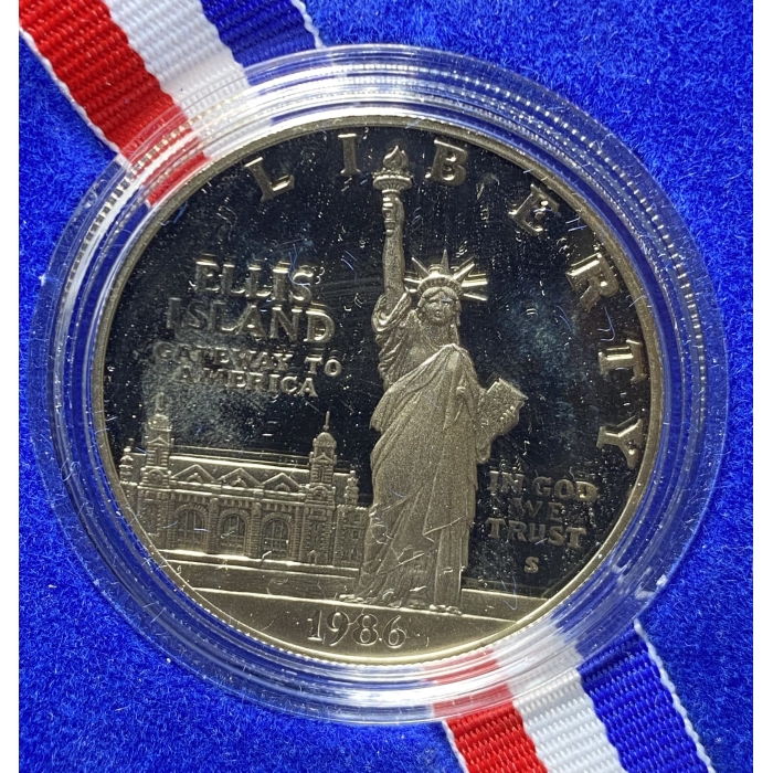 1986 Statue of Liberty commemorative coin with ribbon.