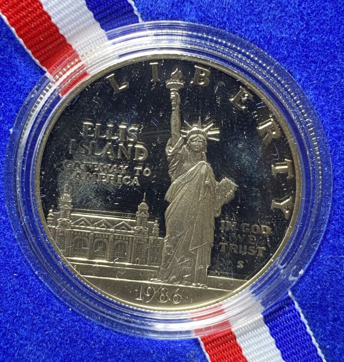 1986 Statue of Liberty commemorative coin with ribbon.