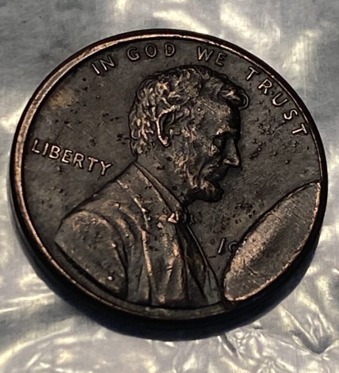 Close-up of a US penny coin, side view.