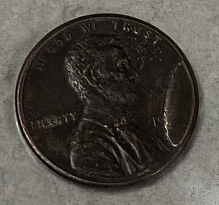 Worn penny showing Abraham Lincoln profile