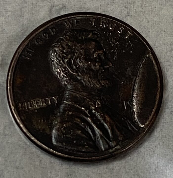 Close-up of a scratched penny coin