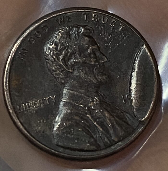 Close-up of a worn penny coin.